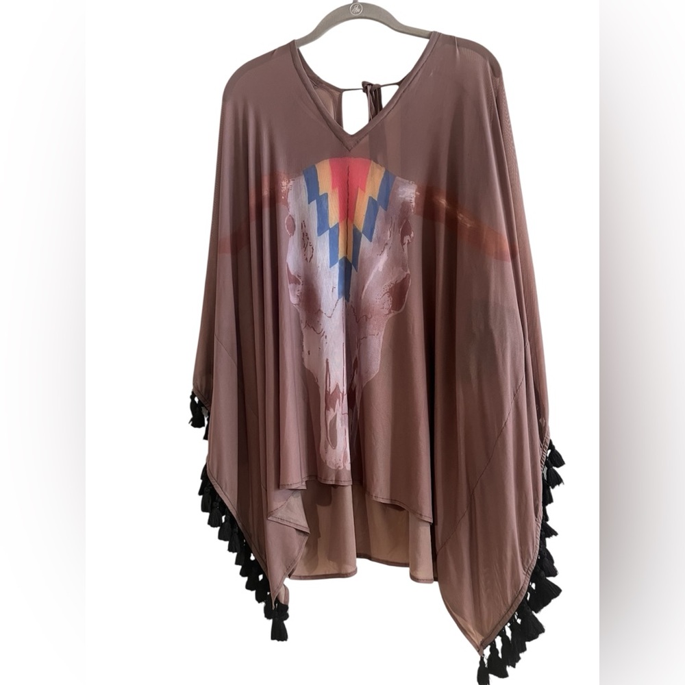 Bohemian-style poncho or featuring a graphic cow skull print & tassel details OS